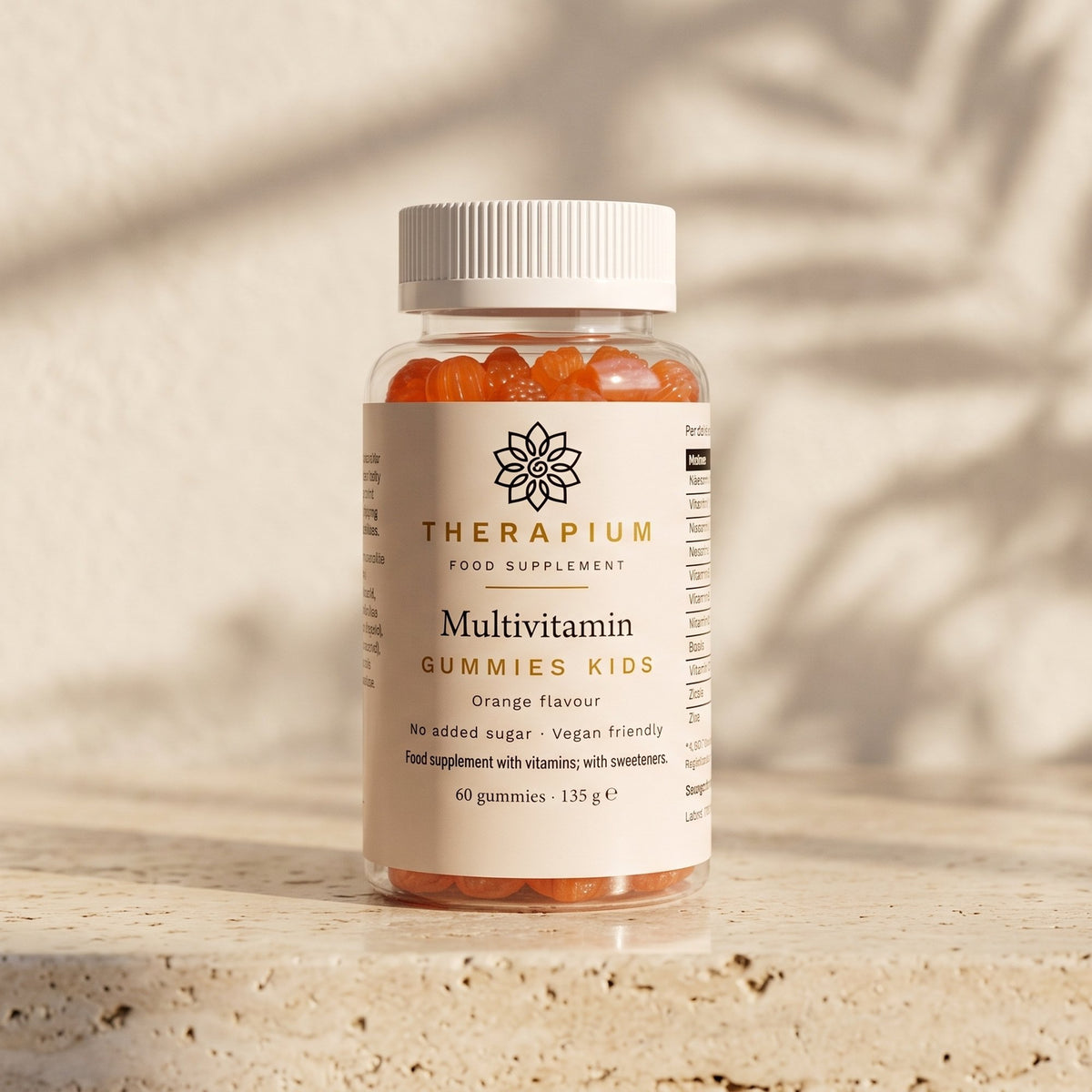 Therapium Multivitamin Gummies Kids jar standing on a travertine stone ledge in warm morning light