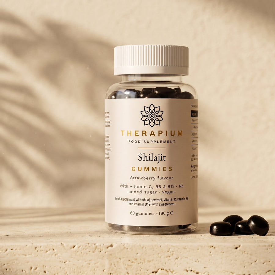 Therapium Shilajit Gummies, the jar on a travertine ledge in morning light with three dark gummies beside it