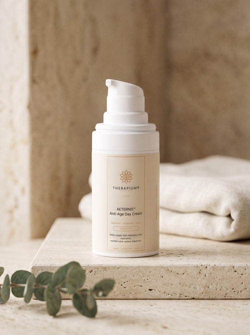 Therapium AETERNIS Anti-Age Day Cream pump bottle on a travertine shelf in morning light