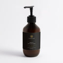 Therapium SERICA Silk Hand Cream, Woody Amber & Leather, 270 ml amber pump bottle with black label, front view on a plain studio background