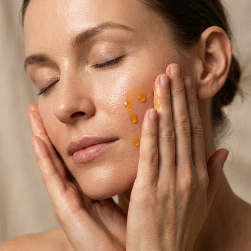 Woman pressing Therapium All-in-One Facial Oil into her skin