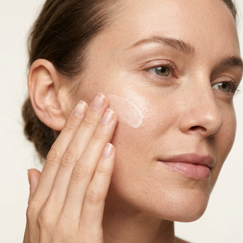 Woman applying Therapium Moisturising Day Cream to her cheek