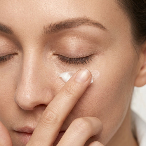 Woman applying Therapium Smoothing Eye Cream under the eye