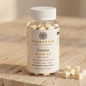 Therapium Creatine Gummies Apple jar on travertine stone, pale cream gummies beside it
